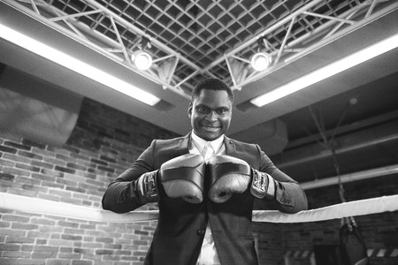 Businessman with boxing gloves ready corporate battle.の写真素材