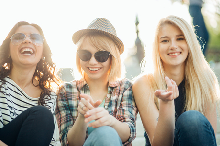 lifestyle portrait of three women enjoy nice day, wearing bright sunglassesの写真素材