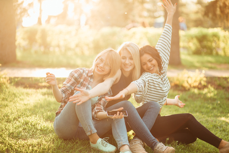 young women enjoying while spending a day in nature and having fun and laughingの写真素材