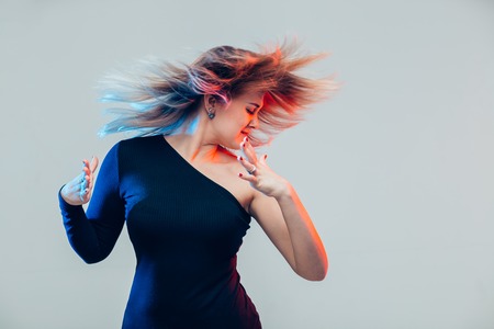 studio portrait of cheerful fashion hipster girl dancingの写真素材