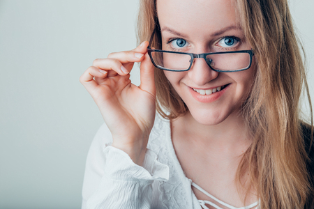Smiling Young Business Woman Wearing Eye Glasses Looking at the Cameraの写真素材