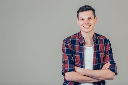 Handsome young man looking at camera. Portrait of laughing young man