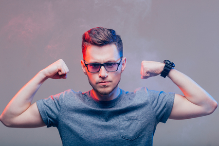 Picture of attractive young man showing his biceps.の写真素材