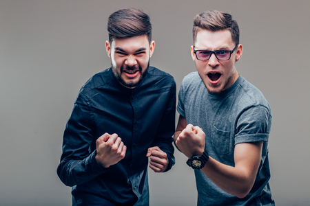 two Caucasian people man expressing their excitement and delight by shouting Yesの写真素材