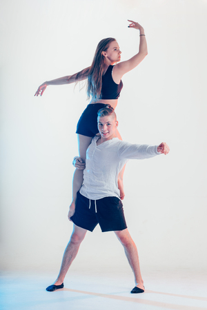 modern style beautiful dancers working out. Young man holding his girl partnerの写真素材