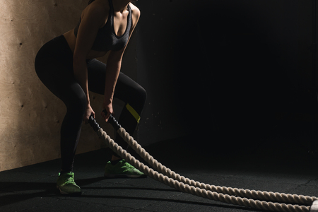 battling ropes girl at gym workout exercise fitted bodyの写真素材