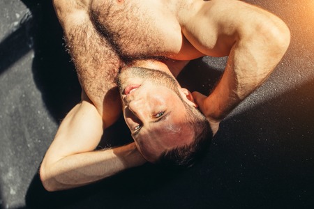 Muscular man exercising doing sit up exerciseの写真素材