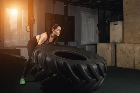 female flipping tire at the gym.の写真素材