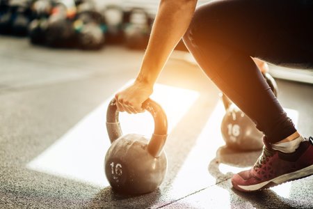 woman standing on knee and preparing for cross fit exercise