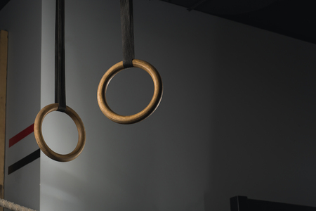 Gymnastic rings suspended on straps on crossfit gymの写真素材