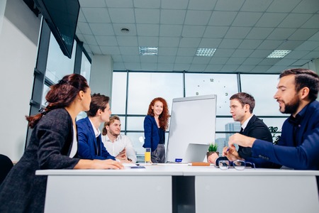 Business woman giving presentation to colleagues in officeの写真素材