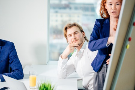 Business woman giving presentation to colleagues in officeの写真素材