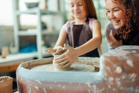 teacher and student make pitcher of pottery wheelの写真素材