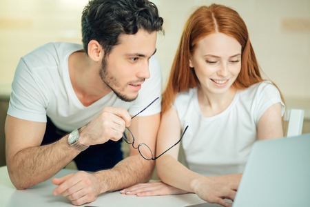couple watching photoes from honey moon together, embracing. They are so happyの写真素材