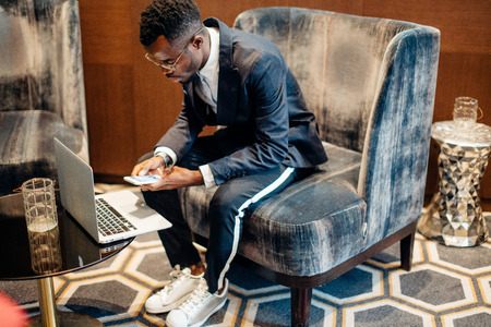 Employee wearing suit working online on laptopの写真素材