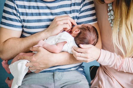 Close up father holding his newborn sonの写真素材
