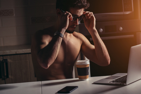 Fit Man Using Laptop - Muscular Athletic Bodybuilder Fitness Model Use Computerの写真素材