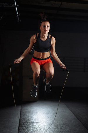 woman Exercises with Jump or Skipping Rope in Gymの写真素材