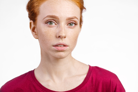 beautiful young redhead girl with clean fresh face and neutral emotions close upの写真素材