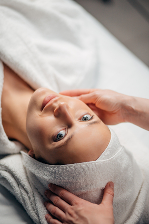 girl having spa facial massage in luxurious beauty salonの写真素材