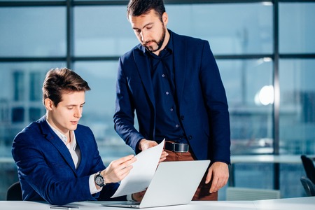 business partners working with laptop togetherの写真素材