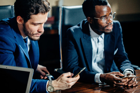 team of african and caucasian entrepreneurs meeting in officeの写真素材