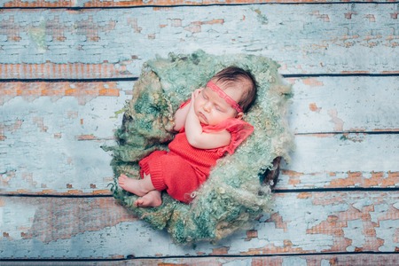 sweet newborn baby sleeping in children nestの写真素材