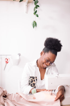 African seamstress sews clothes