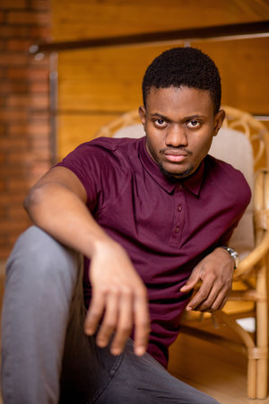 black man sitting on the floor and looking at camera