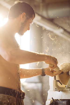 Wood lathe. Carpenter lathing woodの写真素材