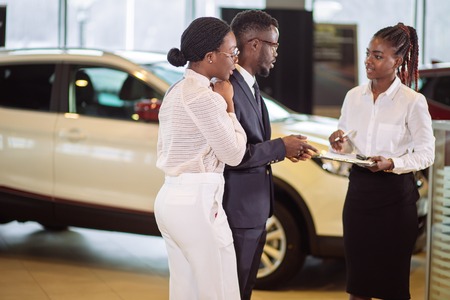 Customers signing some important documents at new car showroomの写真素材