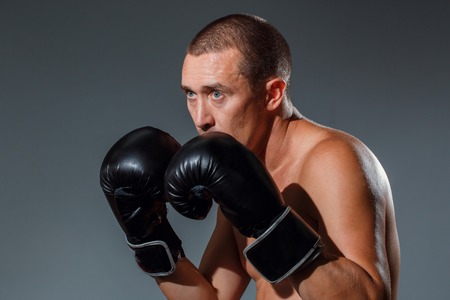 Sporty man during boxing exercise making direct hitの写真素材