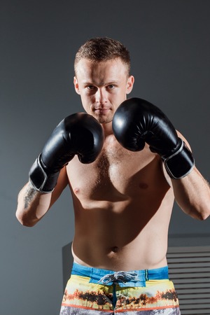 portrait of boxer in Boxing gloves on gray backgroundの写真素材