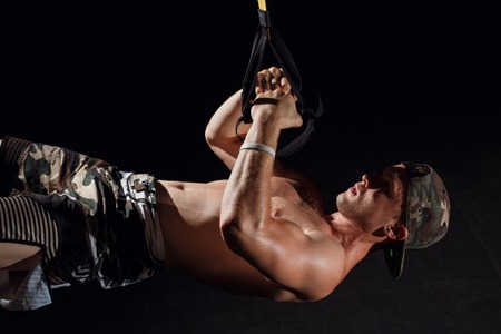 TRX training. Cross fit instructor at the gym doing TRX Excersise.の写真素材