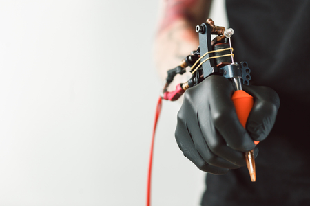 Tattoo artist holding tattoo machineの写真素材