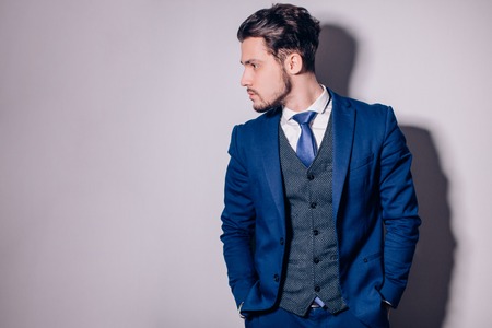 happy businessman with arms crossed standing in officeの写真素材