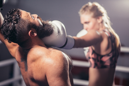 Man get hit by woman Boxer in ringの写真素材
