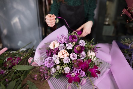 delightful purple flower bouquet lying on the deskの写真素材