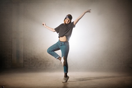 young street dancer performing ballet. doing ballet movementsの写真素材