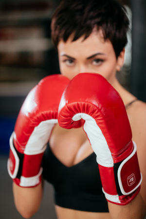 beautiful bold female boxer wearing red sparring gloves. agression.の写真素材
