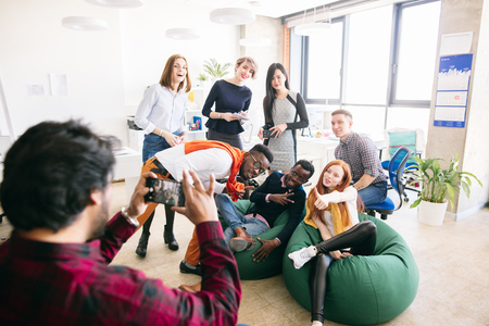 stylish young diverse students are posing to the camera for journalistの写真素材