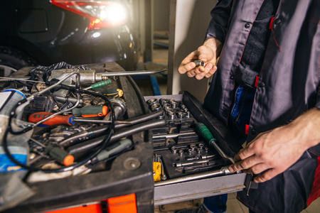 Mechanic taking facilities from special box for mechanical instrumentsの写真素材