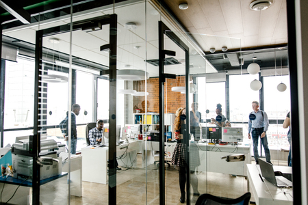 modern bright small office with glass walls, glass door, panorama windowの写真素材
