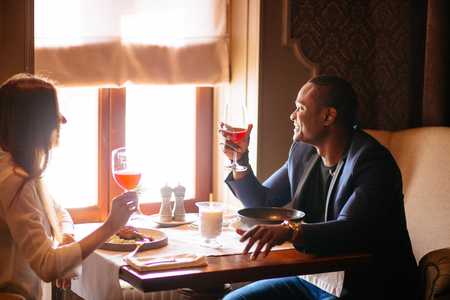 Group of mixed-race friends celebrating birthday at coctail barの写真素材