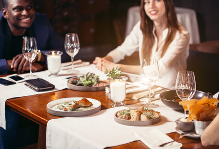 Group of friends enjoying an evening meal at a restaurant.