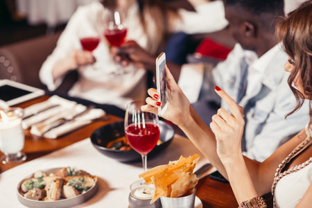 Group of mixed-race friends celebrating birthday at coctail bar