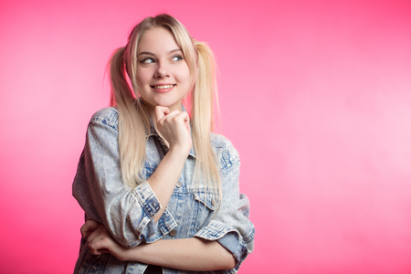 Portrait of a beautiful happy woman smiling on pink backgroundの写真素材