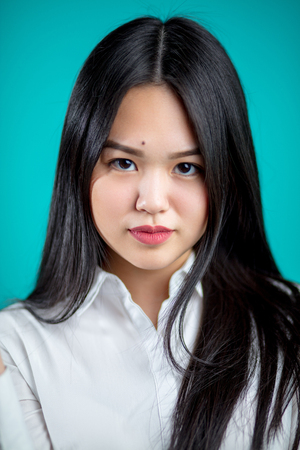 CLose up portrait of long hair Asian woman with white shirt.の写真素材