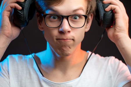 close up portrait of funny singer taking off headphonesの写真素材