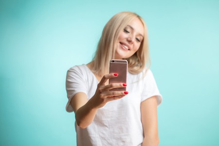 close up portrait of good-looking blond student taking a photoの写真素材